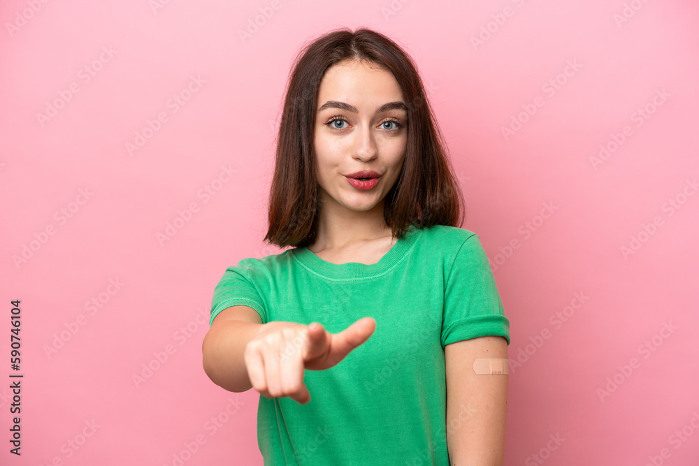 Fototapeta premium Young Ukrainian woman wearing a band aids surprised and pointing front