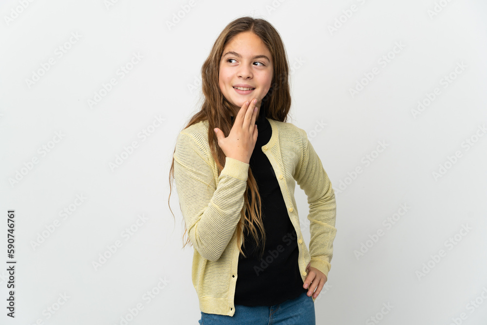 Little girl over isolated white background looking up while smiling Little girl over isolated white background looking up while smiling