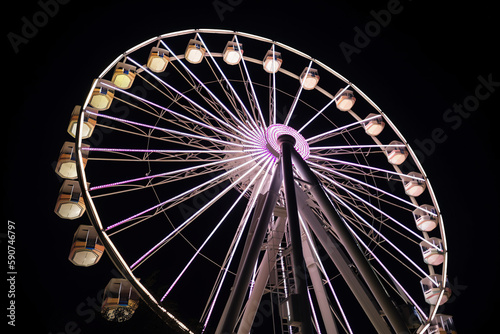 Ferris wheel tivoli at night with neon lights -  generative ai