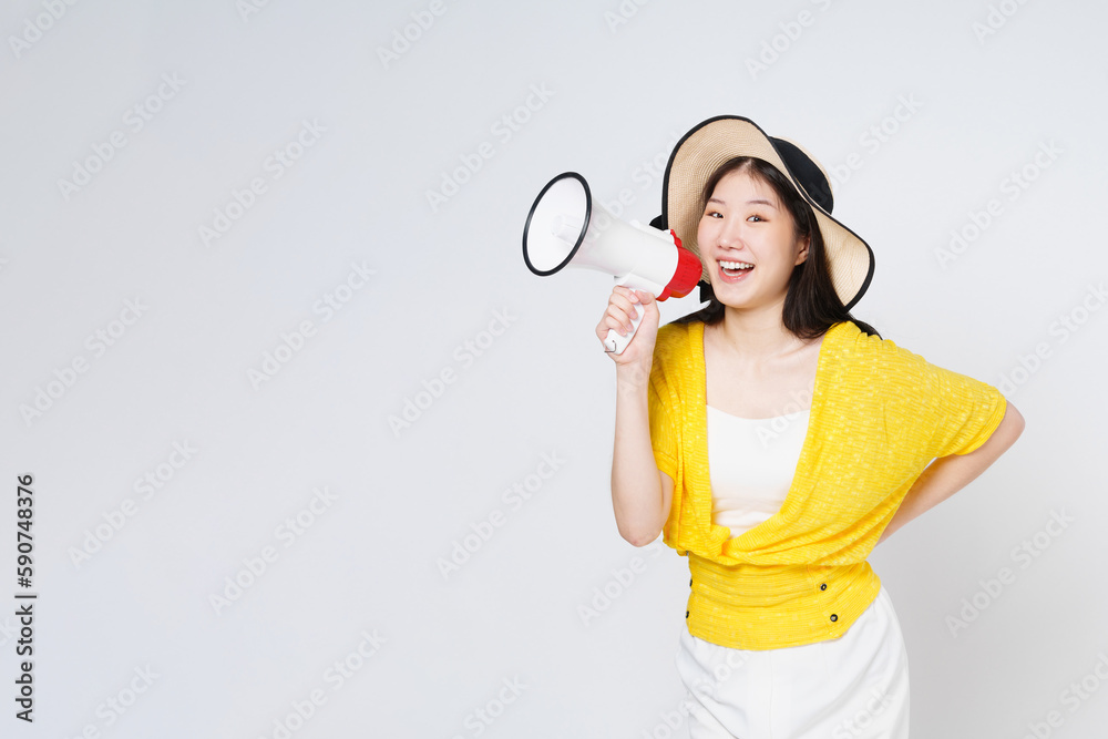 Young woman wearing sun hat and holding megaphone isolated on white background. Lifestyle summer and announce concept. Young woman wearing sun hat and holding megaphone isolated on white background. Lifestyle summer and announce concept.