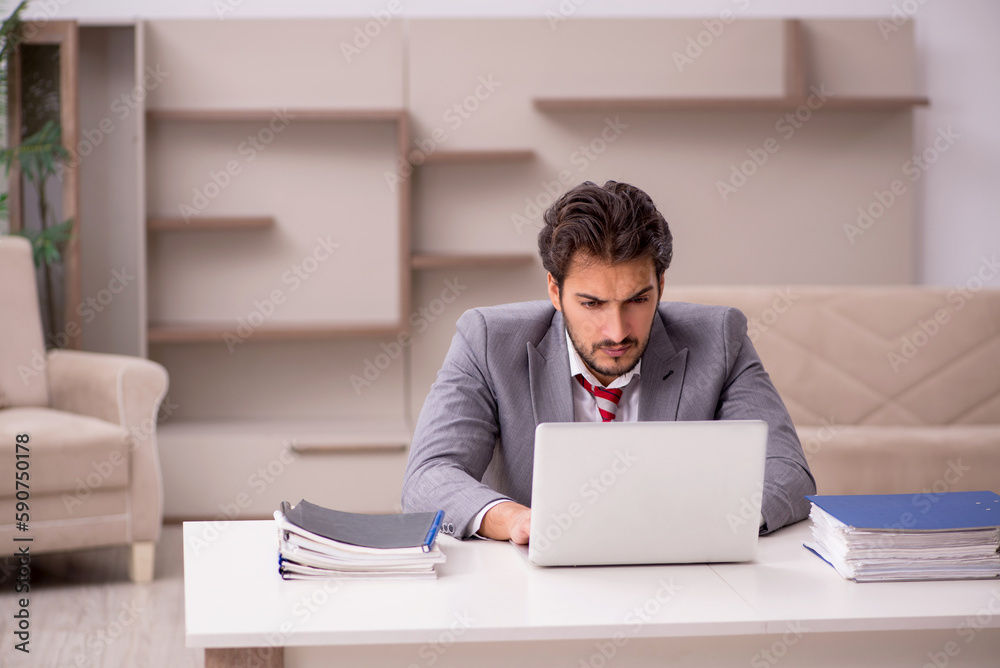 Young male employee working from home during pandemic Young male employee working from home during pandemic