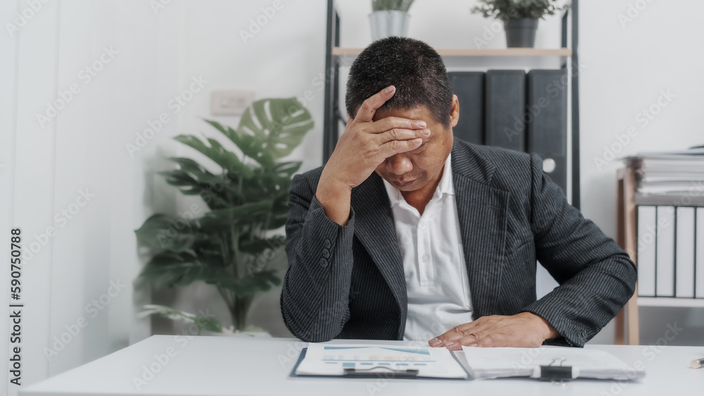 Tired, Elderly Old Senior Asian male businessman wearing formal suit ,confident professional bookkeeper doing bookkeeping, lawyer, stock market trader or broker. Tired, Elderly Old Senior Asian male businessman wearing formal suit ,confident professional bookkeeper doing bookkeeping, lawyer, stock market trader or broker.