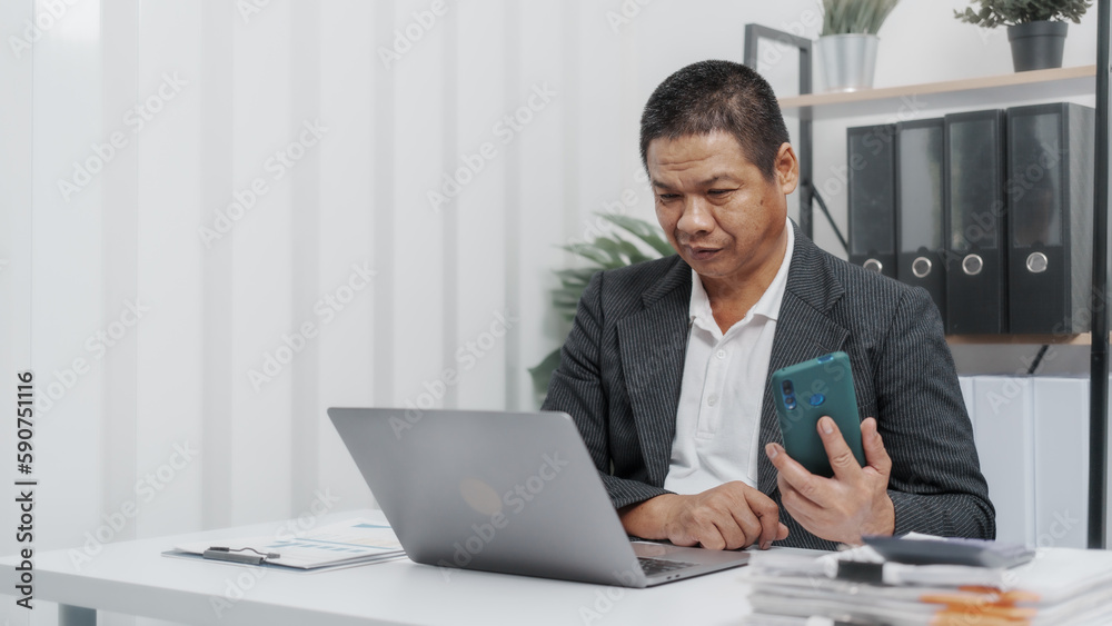 Using laptop pc, Elderly Old Senior Asian male businessman wearing formal suit ,confident professional bookkeeper doing bookkeeping, lawyer, stock market trader or broker. Using laptop pc, Elderly Old Senior Asian male businessman wearing formal suit ,confident professional bookkeeper doing bookkeeping, lawyer, stock market trader or broker.