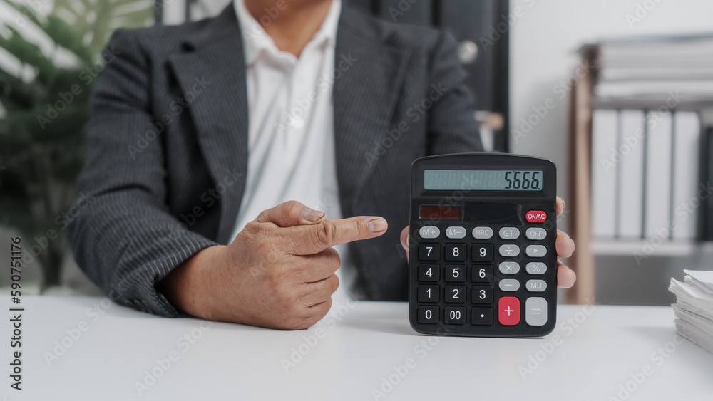Using, calculator, Elderly Old Senior Asian male businessman wearing formal suit ,confident professional bookkeeper doing bookkeeping, lawyer, stock market trader or broker. Using, calculator, Elderly Old Senior Asian male businessman wearing formal suit ,confident professional bookkeeper doing bookkeeping, lawyer, stock market trader or broker.