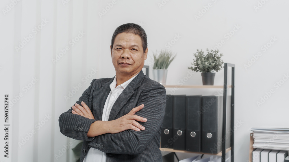 Standing, crossed hands, Elderly Old Senior Asian male businessman wearing formal suit ,confident professional bookkeeper doing bookkeeping, lawyer, stock market trader or broker. Standing, crossed hands, Elderly Old Senior Asian male businessman wearing formal suit ,confident professional bookkeeper doing bookkeeping, lawyer, stock market trader or broker.