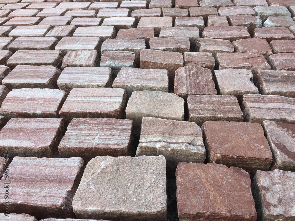 Beautiful tiled stone pavers arranged on the street without a sealant in between