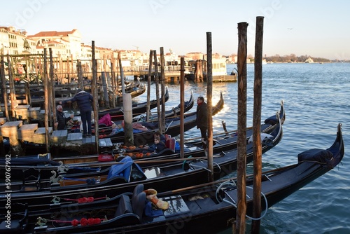 Canoes on the pier of the Venetian Canal during the Venice Festival © Iryna