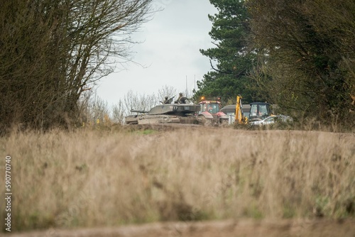 Military tanks moving in a field