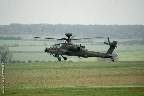 Attack helicopter performing low level hover maneuver