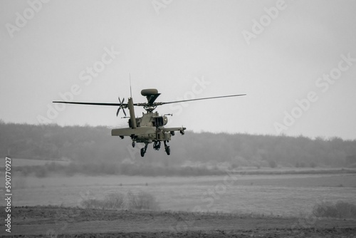 Attack helicopter performing low level hover maneuver