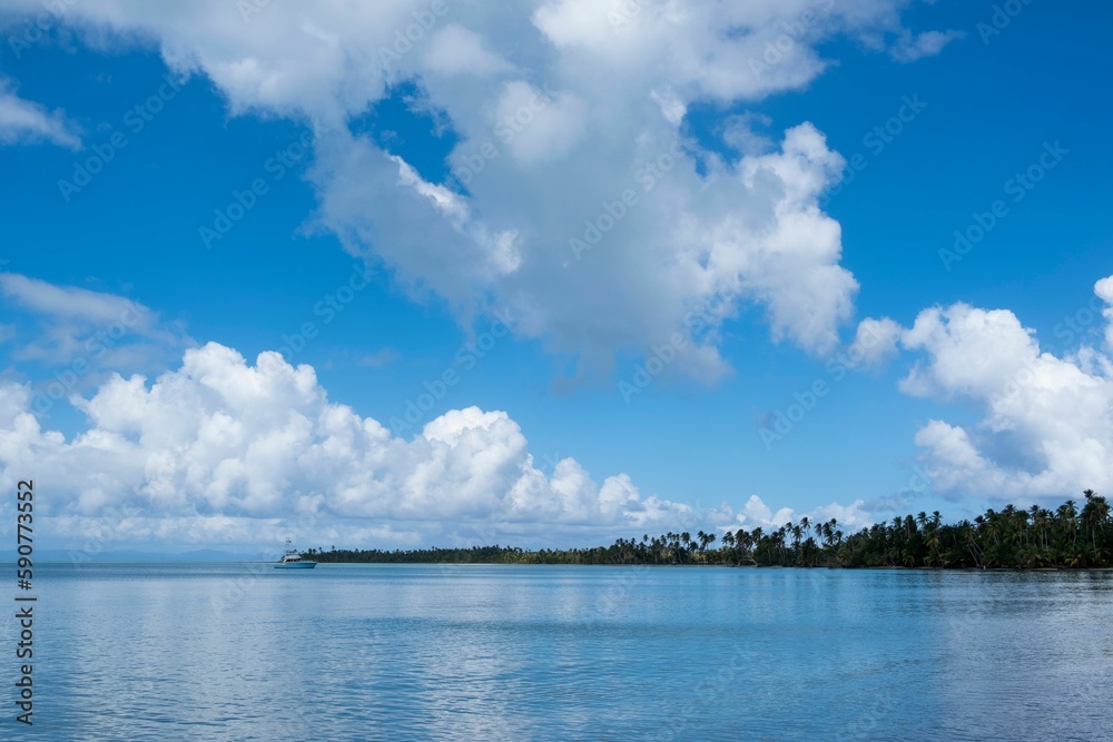 Scenic view of a beautiful blue seascape with white puffy clouds in the sky