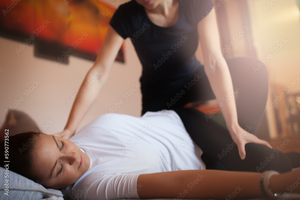 A beautiful masseuse performs massage therapy in a private SPA center while a beautiful woman enjoys the charms of massage A beautiful masseuse performs massage therapy in a private SPA center while a beautiful woman enjoys the charms of massage