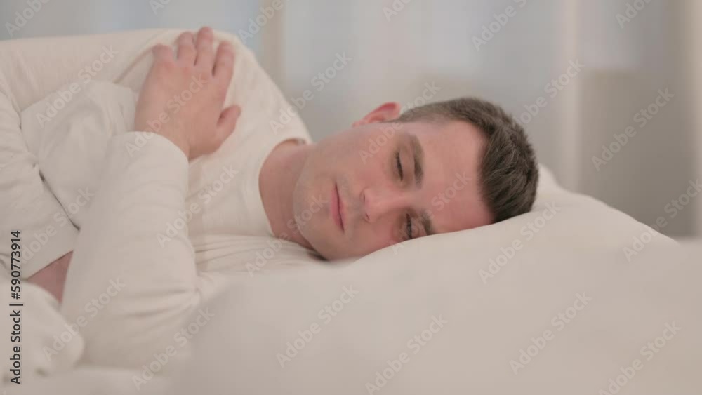 Pensive Young Man Sleeping in Bed on Side Pensive Young Man Sleeping in Bed on Side