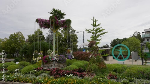 Beautiful view of a flower theme park with a floral wave swinger and floral children photo
