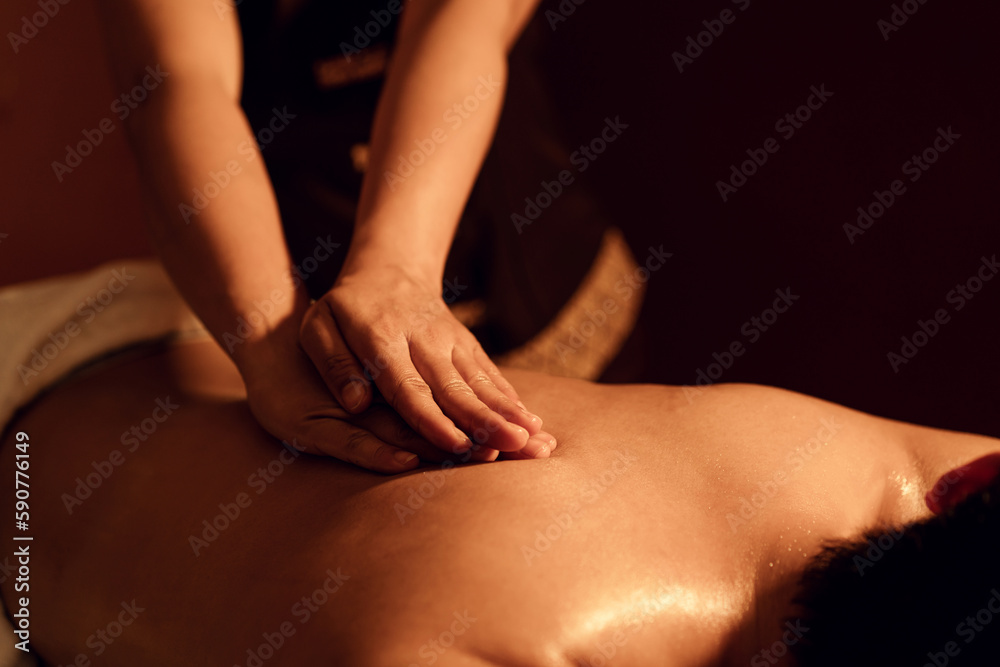 Masseuse hand massage aroma on back a man customer in cosmetology spa centre. - obrazy, fototapety, plakaty 