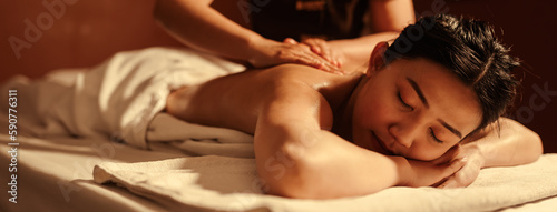 Relaxation Asian woman customer get service aromatherapy massage with masseuse in spa salon.
