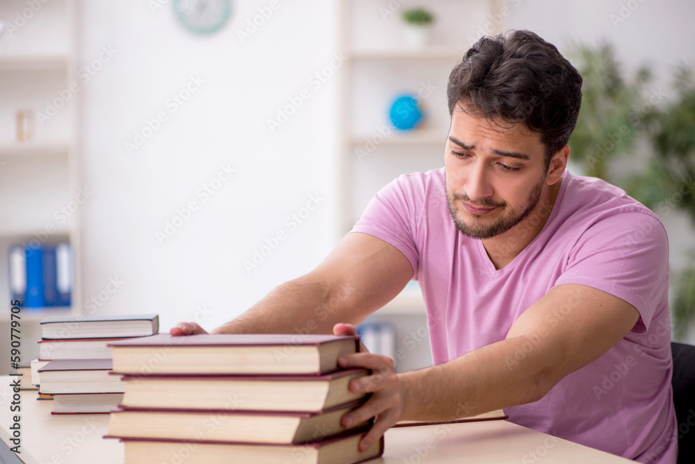 Young male student sitting in the classroom Young male student sitting in the classroom