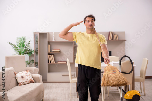 Young man doing housework indoors © Elnur