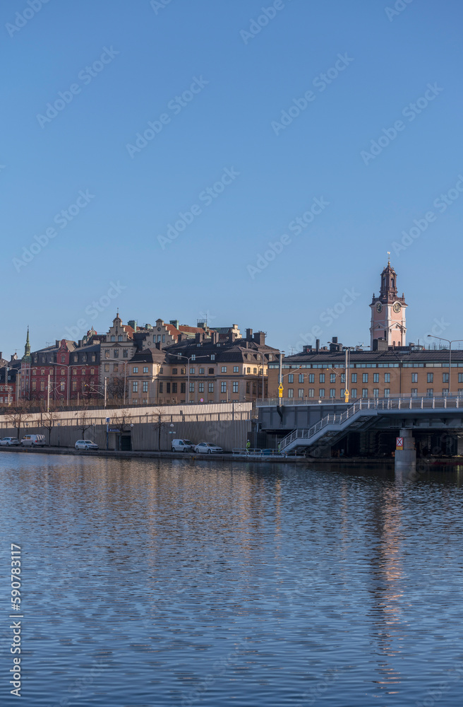 Fototapeta premium A bridge at the old town Gamla Stan and the church Tyska kyrkan, a sunny spring morning in Stockholm