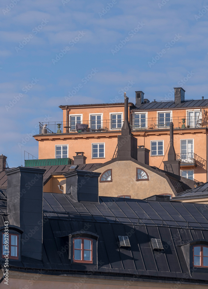 Old apartment houses on the cliff Mariaberget with towers and dorms, a sunny spring morning in Stockholm 