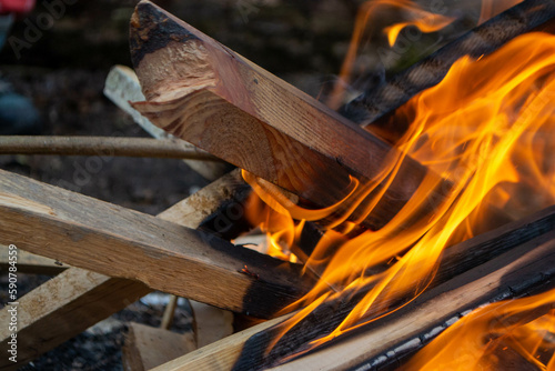 A fire burns in a campfire with a red fire in the background. High quality photo photo