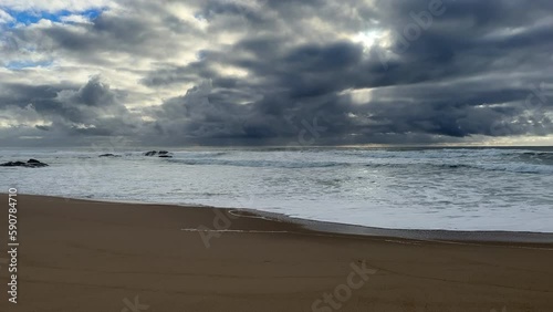 Dark, moody storm clouds gather over the Atlantic ocean in Portugal in early spring, a sure sign of rain.