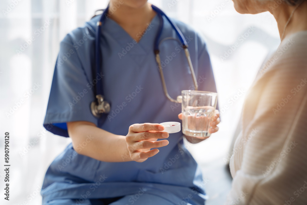 Female therapist recommending pills to elderly patients