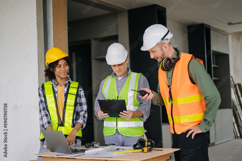 Engineers are discussing data working and laptop or tablet with architectural project at new construction site on big project. Engineers are discussing data working and laptop or tablet with architectural project at new construction site on big project.