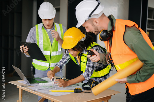 Engineers are discussing data working and laptop or tablet with architectural project at new construction site on big project.