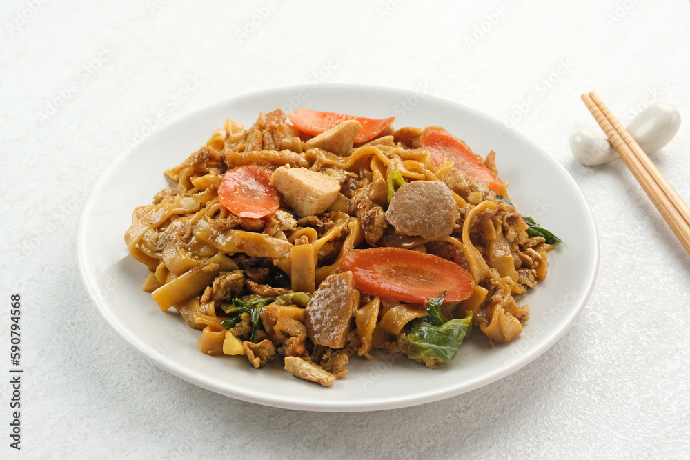 Kwetiaw or Kwetiau, fried rice noodles with meatballs and vegetables. Popular in Indonesia
Kwetiaw or Kwetiau, fried rice noodles with meatballs and vegetables. Popular in Indonesia