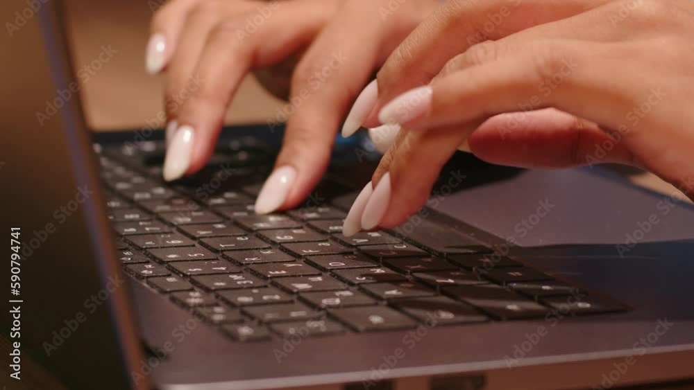 Close up of female hands typing text on laptop keyboard. Concept of