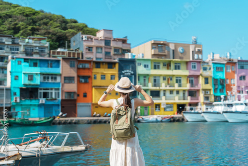 woman traveler visiting in Taiwan, Tourist with backpack and hat sightseeing in Keelung, Colorful Zhengbin Fishing Port, landmark and popular attractions near Taipei city . Asia Travel concept © Jo Panuwat D