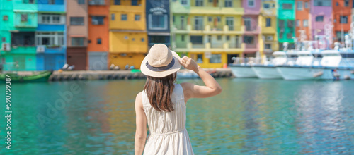 woman traveler visiting in Taiwan, Tourist with hat sightseeing in Keelung, Colorful Zhengbin Fishing Port, landmark and popular attractions near Taipei city . Asia Travel concept © Jo Panuwat D