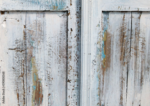 Close-up of antique white wooden cabinet with distressed paint texture and vintage hardware © Mary