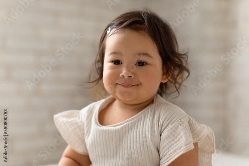 Portrait Of Cute Japanese Baby Girl Posing At Home