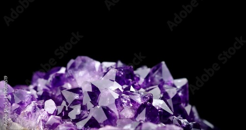 dark crystal amethyst druse 360° rotation in 4k. macro detail texture background. close-up raw rough unpolished semi-precious gemstone photo