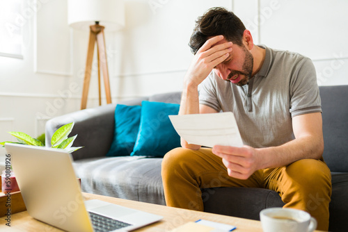 Worried man stressed about doing his taxes