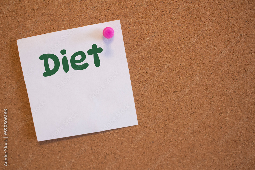 White square sticker with a diet note pinned to a cork board White square sticker with a diet note pinned to a cork board