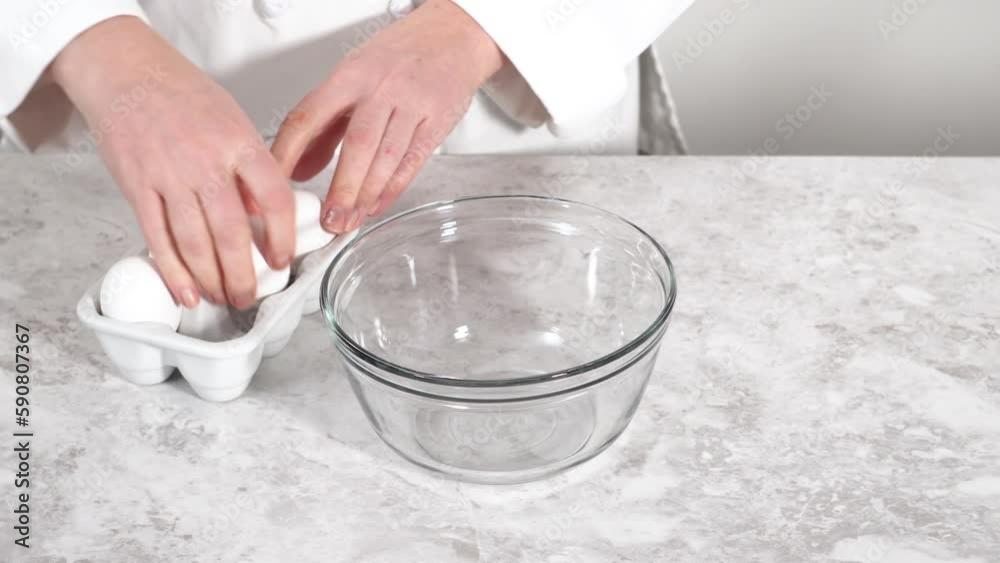 Close up view. Mixing ingredients in a glass mixing bowl to bake funfettti bundt cake. Close up view. Mixing ingredients in a glass mixing bowl to bake funfettti bundt cake.