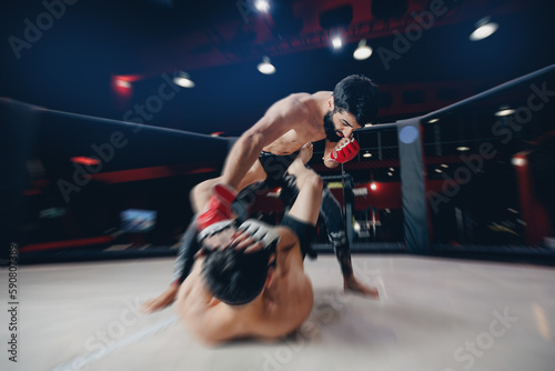 MMA sport, Boxers fighter finishes off enemy in ring octagon, dark background spot light