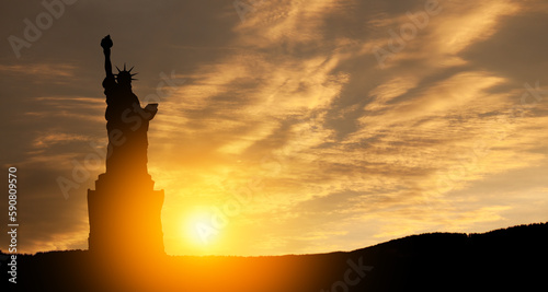 Silhouettes of The Statue of Liberty at sunset. Greeting card for Independence Day. © hamara