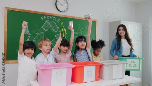 Teacher woman is teaching a class on selecting and separating waste for recycling, Student with recycle trash in classroom at elementary school