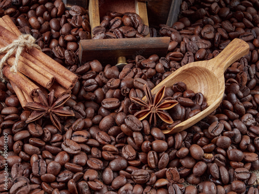 Fototapeta premium Antique vintage retro bronze coffee mill on black wooden board with roasted coffee beans