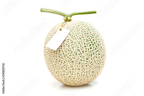 Green melon with white tag on white background. Fruit and nature food background