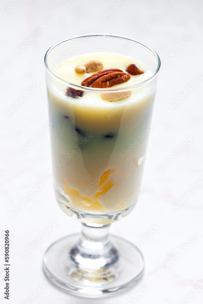 vanilla custard with nuts and raisins in a glass vanilla custard with nuts and raisins in a glass