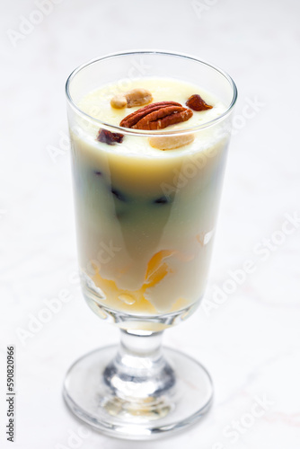 vanilla custard with nuts and raisins in a glass