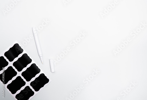 Self adhesive black labels stickers for kitchen organization on a white background with copy space for text