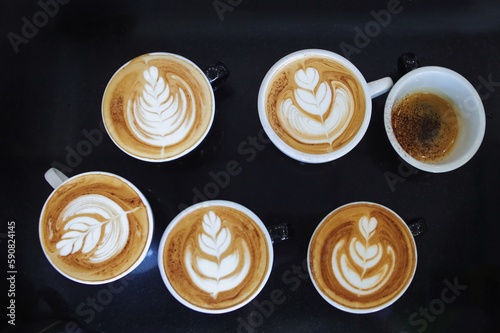 Top view cup of coffee latte on dark background.