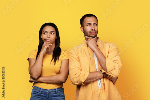 Pensive millennial african american boyfriend and woman looking at empty space, think