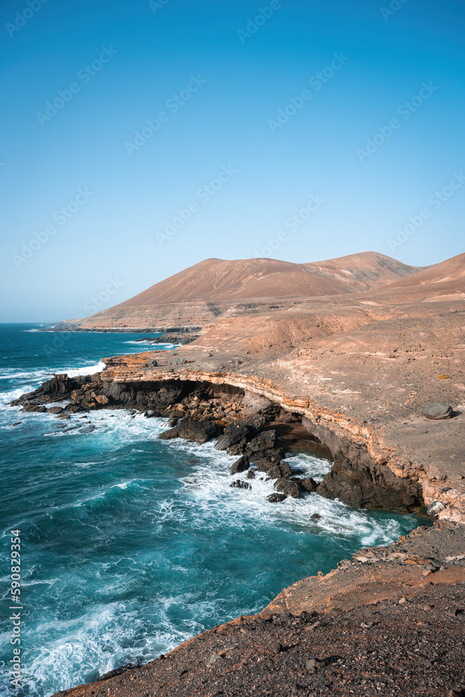 Stunning view of a rocky coastline bathed by a beautiful blue ocean. Playa del Aguila (Eagles' Beach) Fuerteventura, Canary Islands, Spain...